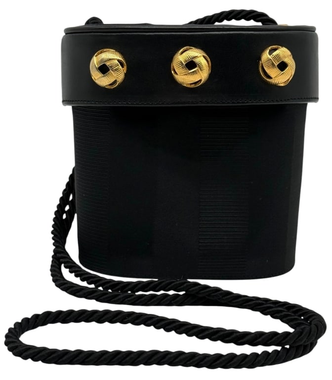 SALVATORE FERRAGAMO BLACK BUCKET EVENING BAG: Vintage Salvatore Ferragamo black bucket-style evening bag with gold-tone decorative hardware and twisted rope shoulder strap. Features a structured silhouette with fabric and leather construction and