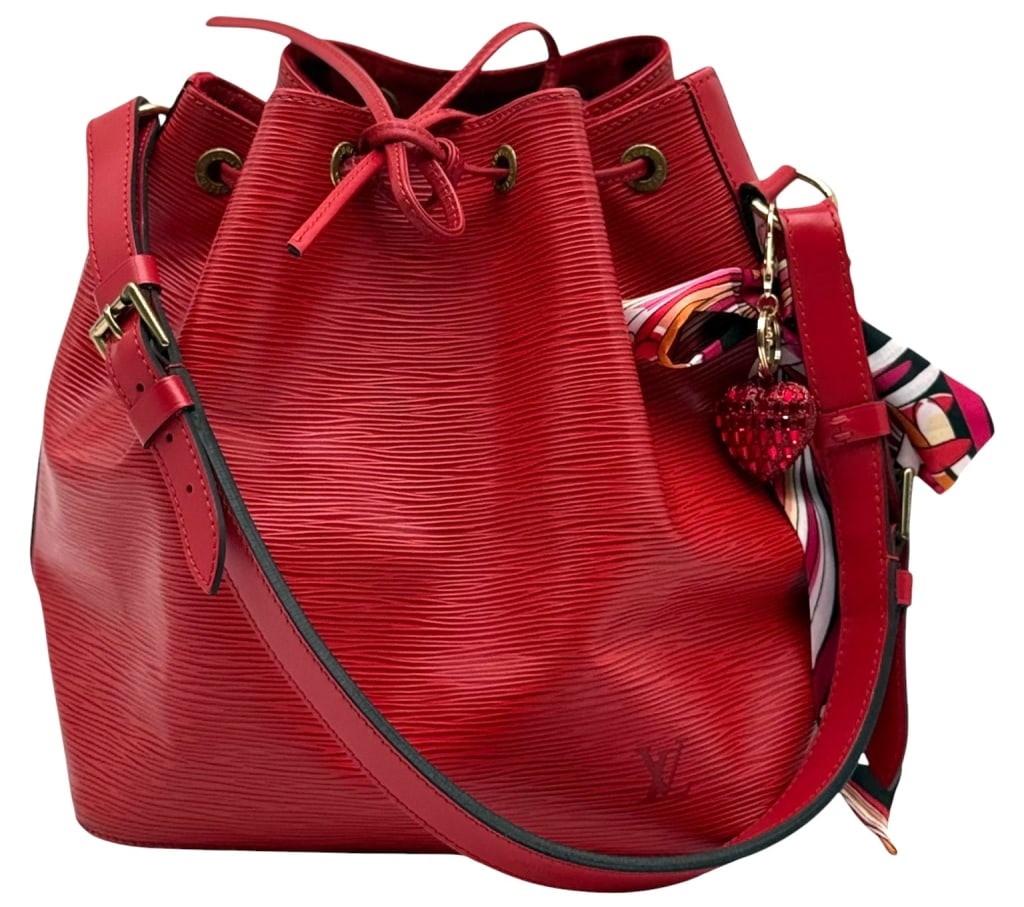 LOUIS VUITTON RED EPI LEATHER NOE SHOULDER BAG: Louis Vuitton Noe bucket bag crafted in red Epi leather with adjustable shoulder strap and drawstring closure. Features gold-tone hardware, embossed LV logo, and the classic spacious bucket silhouette