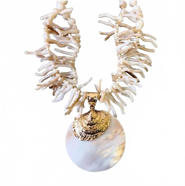 Statement Shell and Coral Reef Necklace: Bold designer necklace featuring a large round iridescent shell pendant with gold accent, suspended from a strand of detailed faux coral branches and beads. Ideal for beach-inspired or tropical looks.