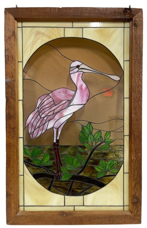 STAINED GLASS ROSEATE SPOONBILL PANEL 39in: Handcrafted stained glass panel depicting a roseate spoonbill standing in a marsh landscape beneath a warm sunset sky. The design incorporates opalescent and textured art glass in shades of pink, crea