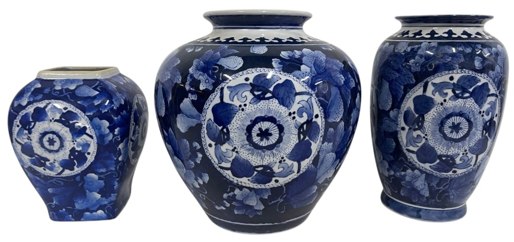 LOT OF 3 BLUE & WHITE CERAMIC VASES 12in: Lot of three blue and white ceramic decorative vases featuring richly detailed floral and botanical motifs with large circular medallion designs. The group includes one large baluster-form vase, one c