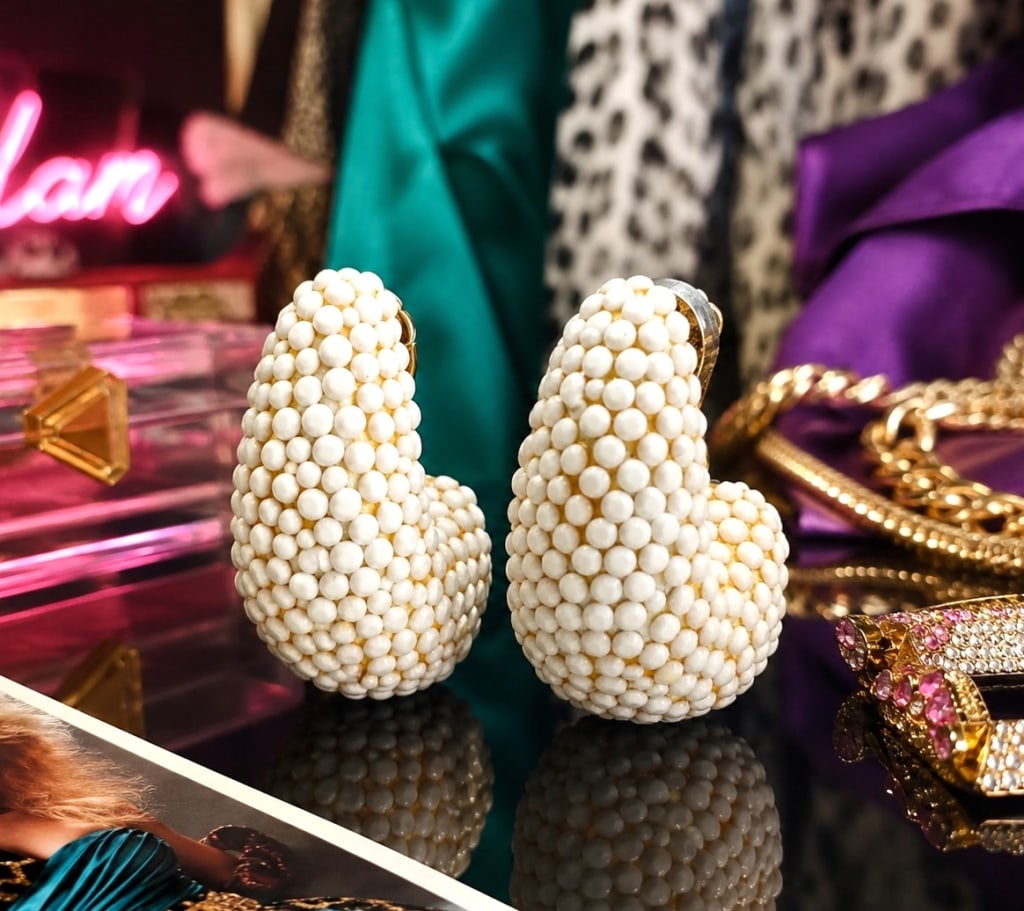 RICHARD KERR VINTAGE NAUTILUS EARRINGS 2in: Vintage signed Richard Kerr clip earrings featuring the designer's iconic dimensional beadwork. Each earring is covered in faceted white beads over a sculptural gold-tone setting with a domed clip top