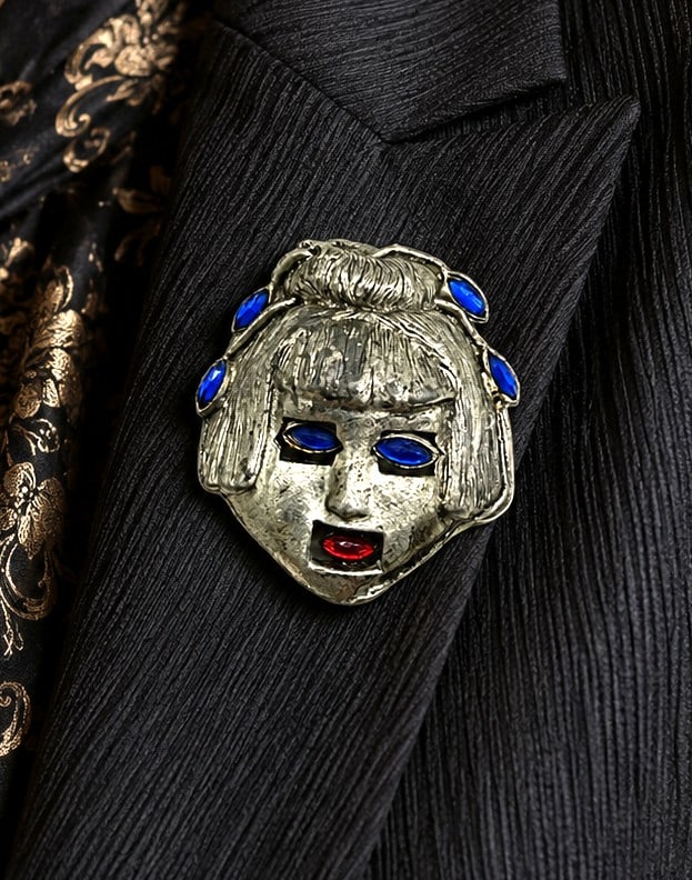 1930S ART DECO GEISHA LADY BROOCH 2in: Vintage Art Deco figural brooch dating to the 1930s, depicting the stylized face of a Geisha style woman rendered in silver-tone metal. The dramatic design features cobalt blue marquise-cut rhinestone