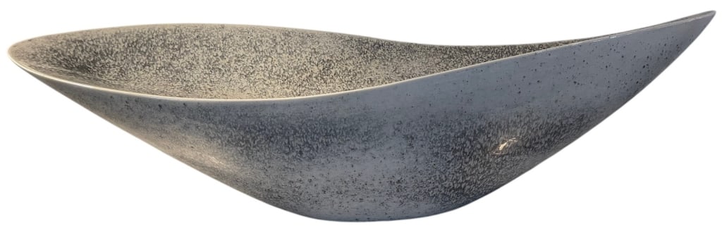 MODERN CERAMIC CENTERPIECE 24in: Global Views handcrafted glazed ceramic centerpiece bowl featuring a dramatic freeform elongated silhouette with gently upturned ends. Finished in a mottled gray and ivory reactive glaze, the sculptur