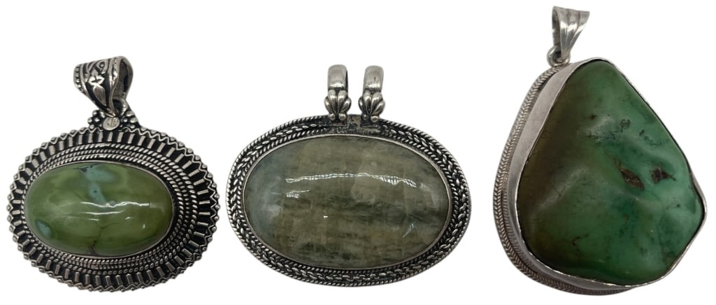 LOT OF 3 STERLING PENDANTS 86.3G 2in: Lot of three sterling silver gemstone pendants featuring polished green cabochon stones in handcrafted bezel settings. The group includes an oval pendant with an ornate Southwestern-style border, an o