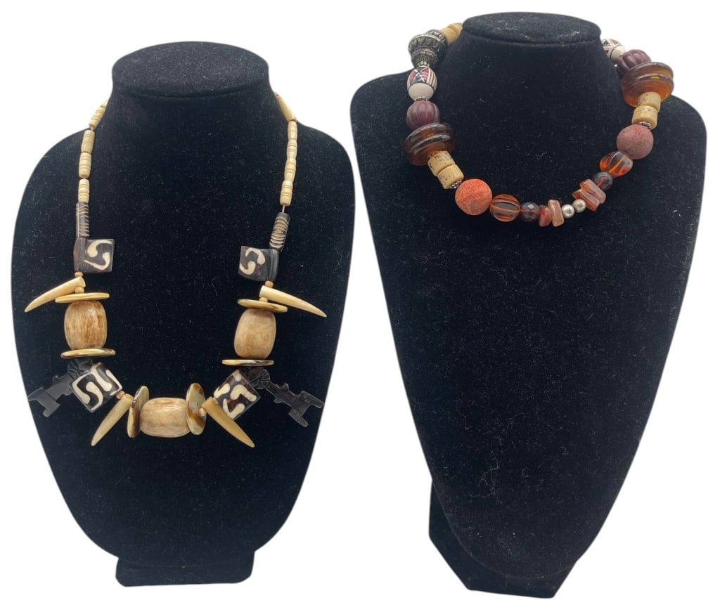 LOT OF 2 ETHNIC BEADED NECKLACES: Lot of two handcrafted ethnic-style necklaces featuring natural materials and decorative beads. One necklace is composed of carved bone-style beads, horn-form accents, and geometric black and cream be
