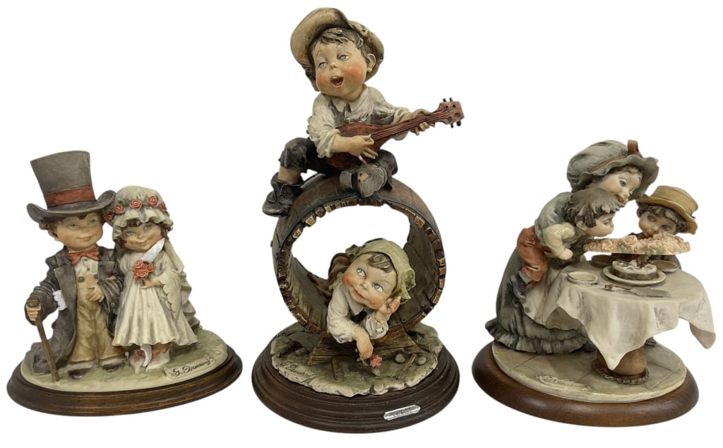 GIUSEPPE ARMANI FIGURINE LOT 12": Lot of three Giuseppe Armani figurines featuring beautifully sculpted children in heartwarming genre scenes. The collection includes a bride and groom, a young musician serenading a child seated in a 