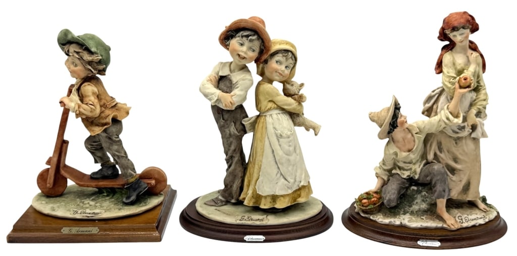 LOT OF THREE GIUSEPPE ARMANI FIGURINES: Collection of three Giuseppe Armani porcelain figurines, each mounted on its original wood display base. The group includes a child riding a scooter, a boy and girl standing back-to-back with a teddy 