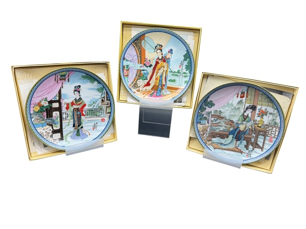 3 CHINESE PORCELAIN PLATES: 3 Chinese porcelain plates featuring colorful scenes with women in traditional attire, each plate in its original box. Each plate measures approximately 8 inches in diameter. Shipping Available at www