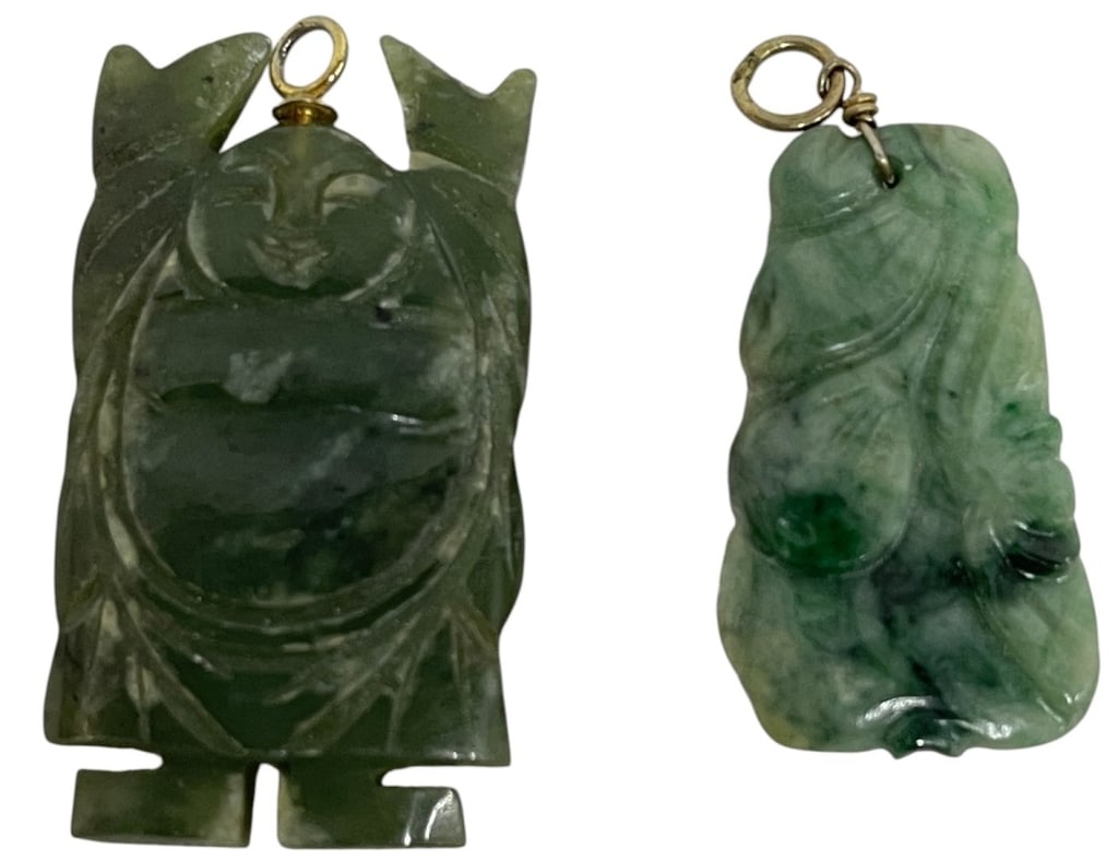 CARVED GREEN JADE PENDANT LOT OF 2 1": Collection of two carved jade pendants featuring traditional figural motifs in variegated green jade. The lot includes a larger stylized figure pendant and a smaller carved pendant with foliate and go