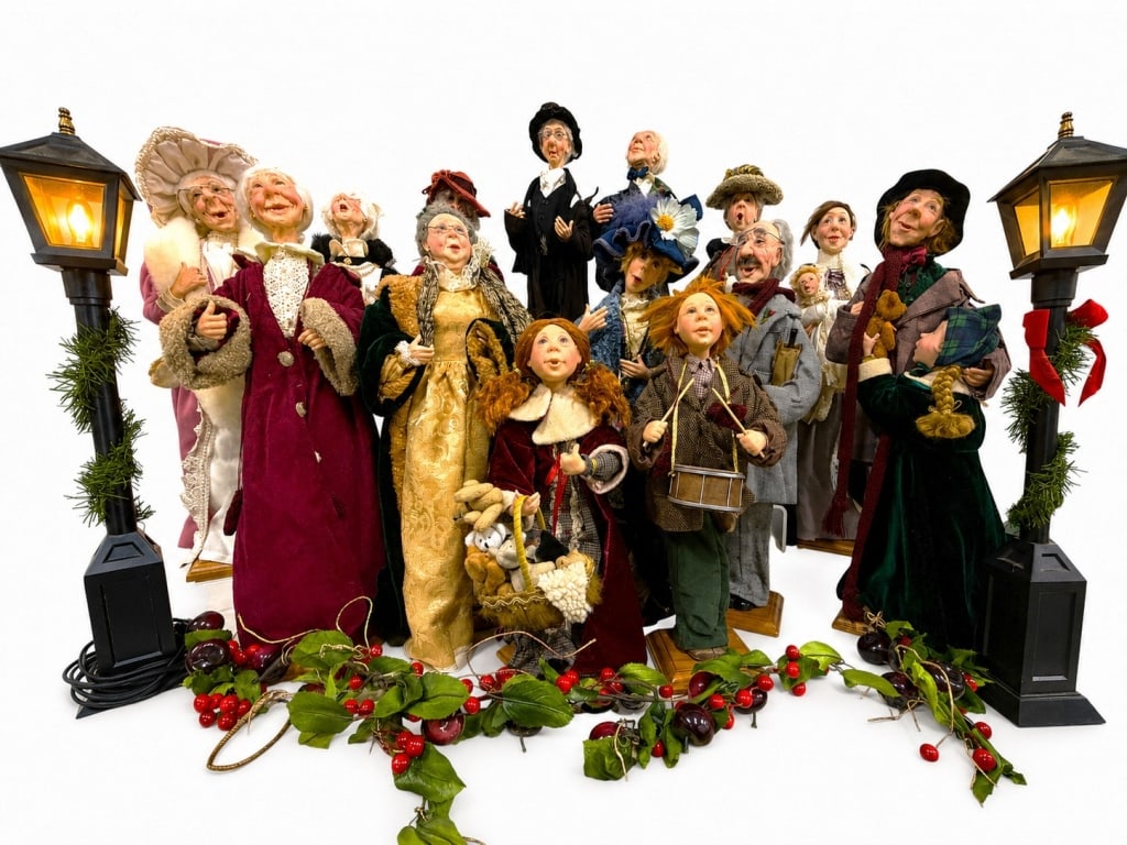 CHRISTMAS FIGURINE GROUP FROM JKC COLLECTION 22": A charming and whimsical fifteen piece collection of holiday figurines from The Jacqueline Kent Collection (JKC), featuring an assortment of richly detailed Victorian-inspired characters, carolers,