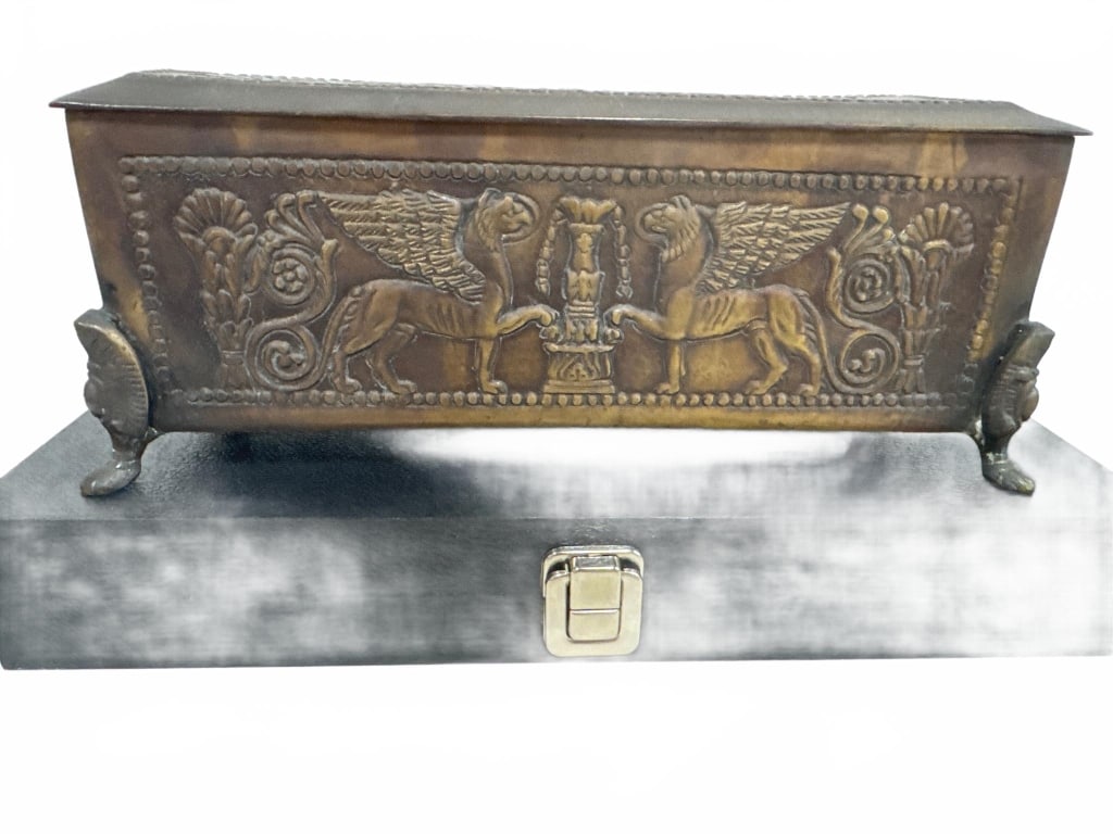 Bronze Mythological Decorated Trinket Box: Bronze trinket box featuring detailed relief of winged mythological creatures. Rectangular form with ornate side feet, measuring approximately 11.5 in. long and 4.5 in. high. Excellent patina, suitabl