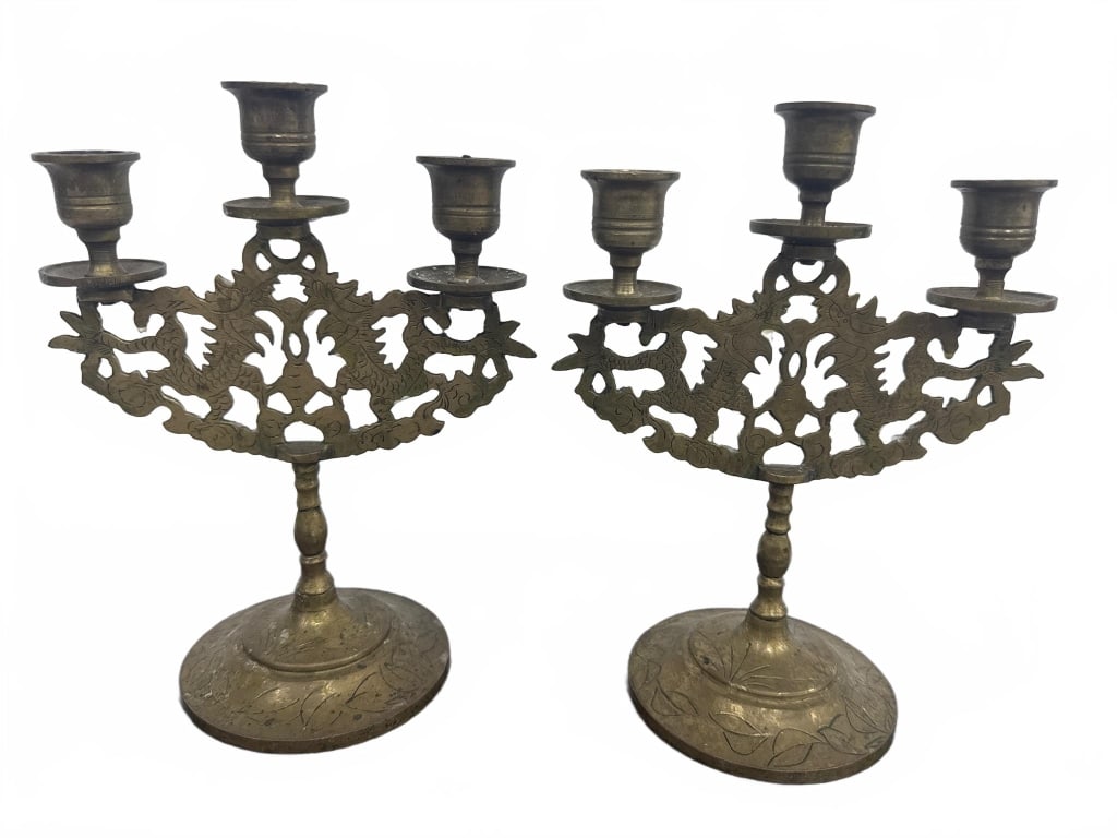 Ornate Brass 3-Arm Candelabras: This pair of vintage brass candelabras each feature three candle holders with intricate openwork floral and leaf designs. Each piece stands approximately 6.5 inches tall. A charming addition to any cl