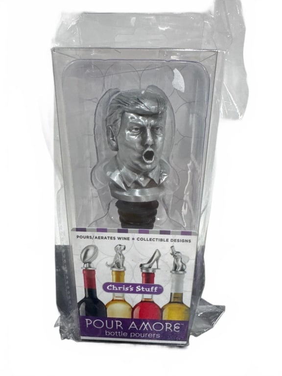 Trump-Shaped Pour Amore Wine Bottle Pourer: Unique Pour Amore wine bottle pourer featuring a caricature of Donald Trump. Made from durable materials, it aerates wine while adding humor to parties and gatherings. New in original packaging, unuse