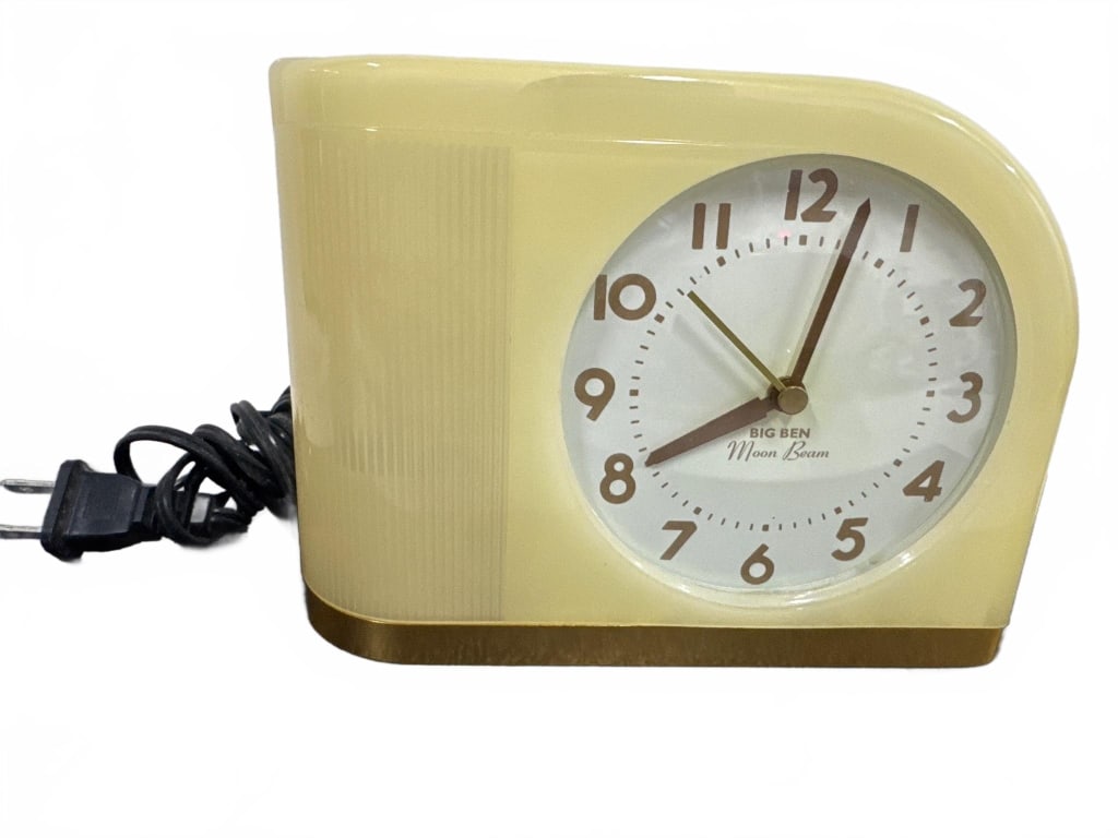 Vintage Big Ben Moon Beam Electric Clock: This vintage Big Ben Moon Beam electric clock features a cream and gold Art Deco design, working corded mechanism, and classic analog dial. Approx. 5.5" tall and 7" wide. Shows some age-related wear b