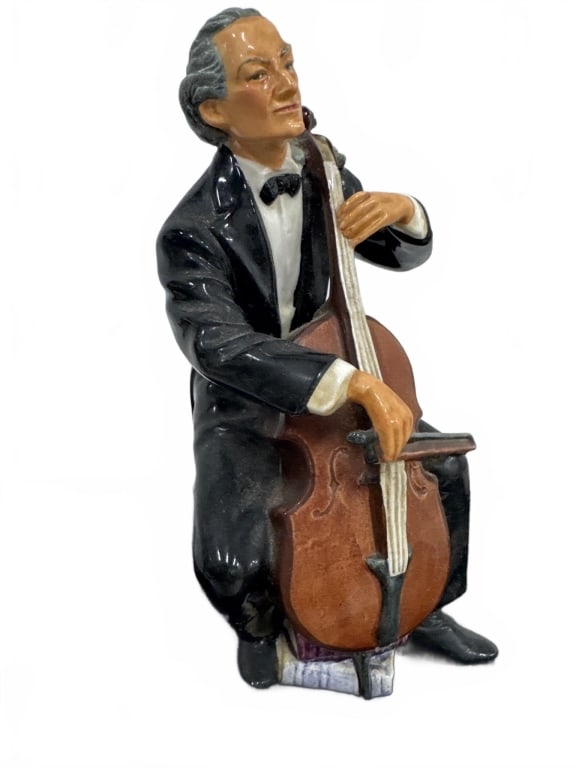 Royal Doulton Figurine 'The Cellist' HN 2302: Hand-painted Royal Doulton porcelain figurine titled 'The Cellist' HN 2302, depicting a seated male cellist in formal attire, circa mid-20th century. Figurine stands approximately 8 inches tall. In ov