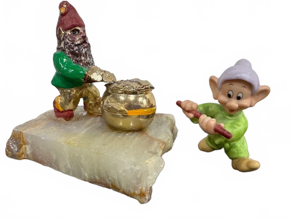 Dwarf Figurines With Pot and Stone Base: Two dwarf figurines: one bearded gnome with green shirt, red hat, and gold accents standing beside a gold pot on a stone base; the other is a light green cartoon dwarf holding a stick. Good condition,