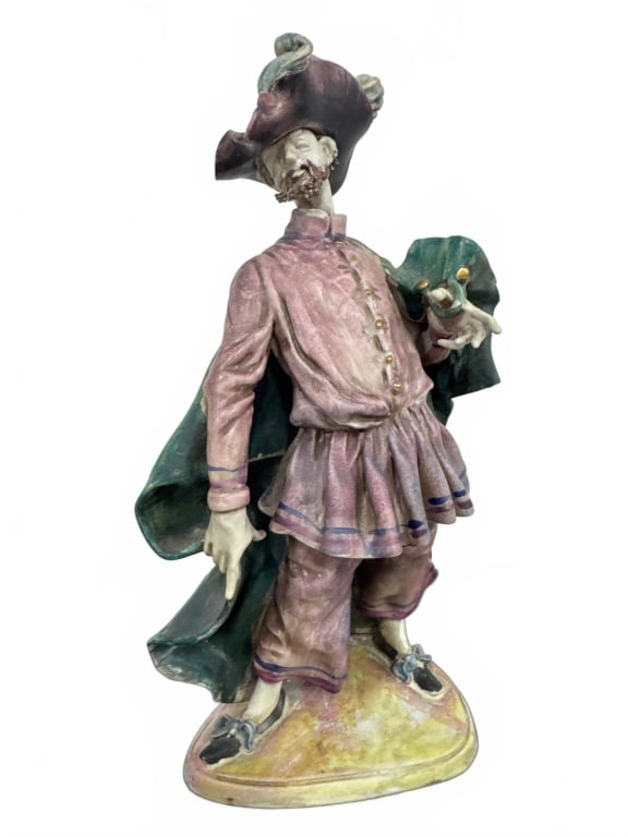 Hand-Painted Ceramic Figurine With Cape: This detailed hand-painted ceramic figurine stands about 12 inches tall. It depicts a whimsical male figure in a period costume with a dramatic green cape and ornate hat. Excellent craftsmanship and s