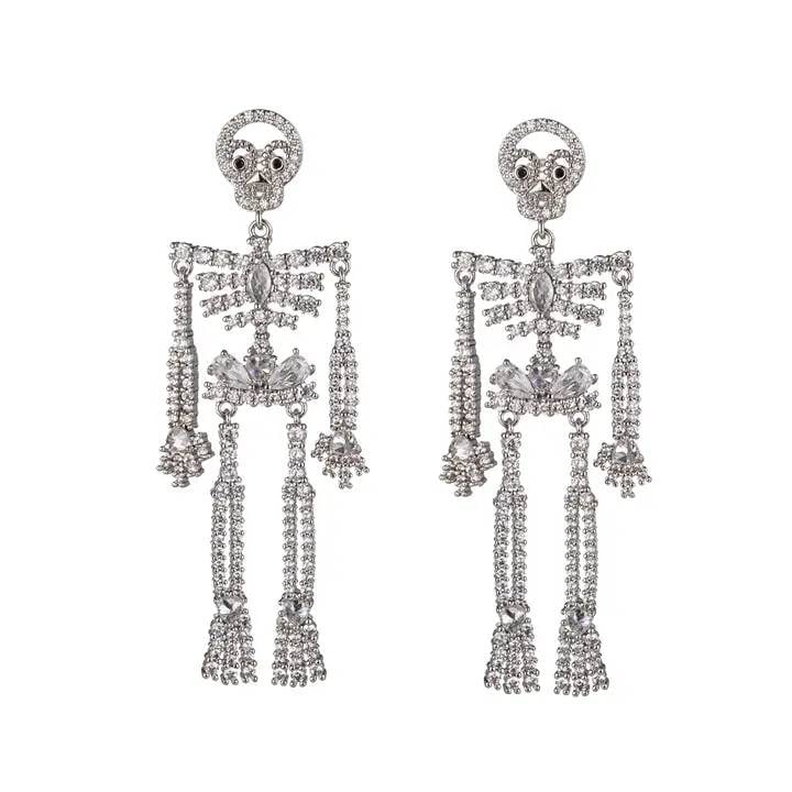 NEW EYE CANDY SILVER SKULL EARRINGS: These Riley Silver Skull Earrings feature a silver tone and a skull-shaped design with a dangle and movement that will enhance any occasion. Wear them to add a little edginess to your everyday look.