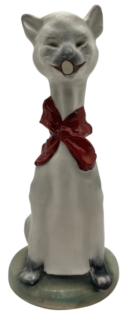 GOLDSCHEIDER STYLE PORCELAIN CAT FIGURE 9": This charming vintage porcelain cat figure features a sleek seated feline with a playful smiling expression and a bold hand-painted red bow tied around its neck. Finished in soft gray and white tones 
