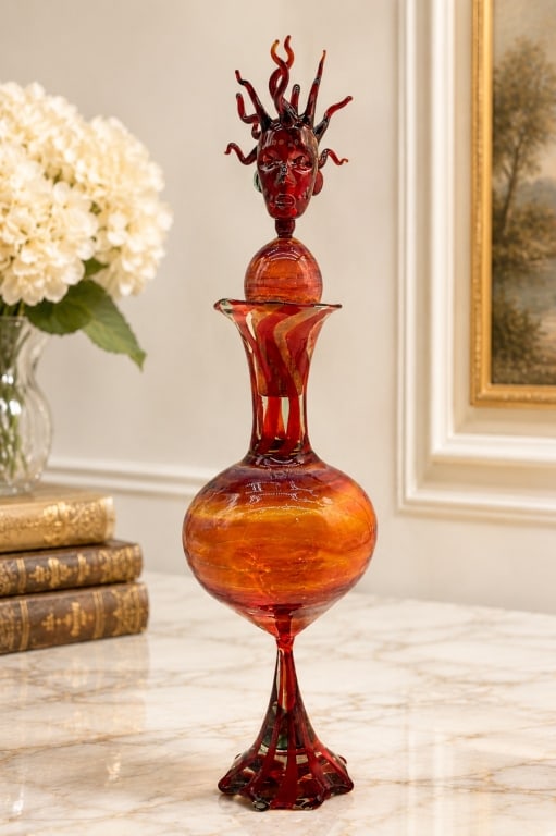 SIGNED RAM STUDIO ART GLASS FIGURAL DECANTER 13 IN: This exceptional contemporary studio art glass decanter features a dramatic sculptural stopper modeled as a stylized human head with flowing flame-like hair, creating a striking surrealist composition
