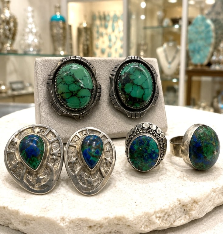 STERLING GEMSTONE RINGS & CLIP EARRINGS LOT 2": Collection of four sterling silver jewelry pieces featuring rich earth-toned cabochon gemstones in vibrant shades of deep blue, green, and blue-green. Included are two sterling silver rings with oval 