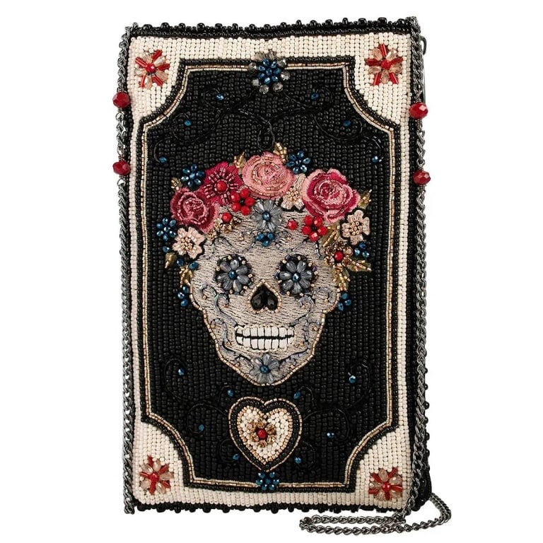 NEW MARY FRANCE FLORAL SPIRIT BAG: A floral crowned skull purse steals the spotlight on a dark, beaded backdrop, framed with tiny blooms and a glowing heart. Moody, romantic, and full of attitude, it?s the kind of crossbody that loves 