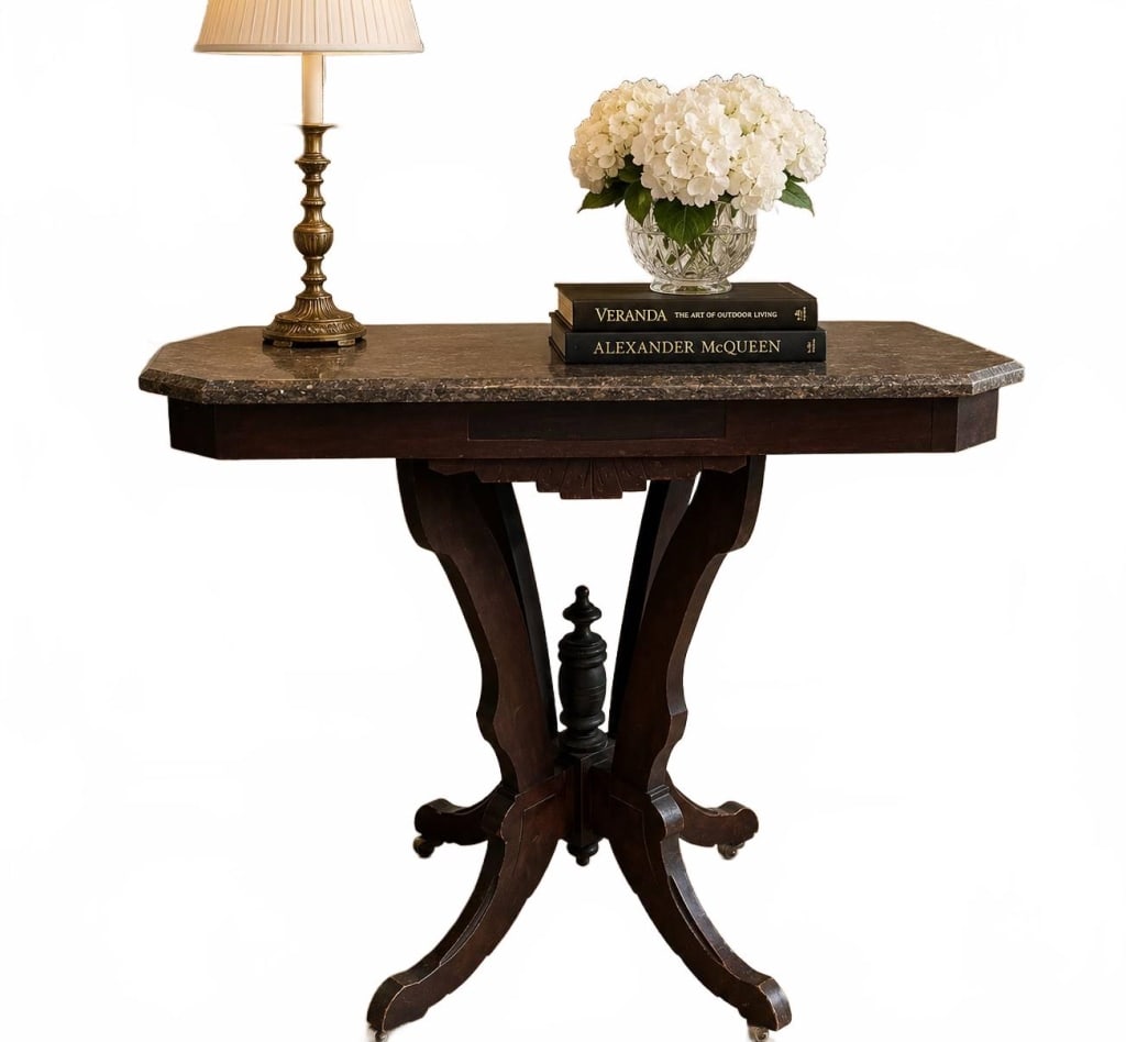 MARBLE TOP PEDESTAL ACCENT TABLE 26": Elegant antique-style pedestal accent table featuring a richly toned wood base with a rectangular polished stone top, likely marble or granite. The table is supported by a decorative four-legged pedes