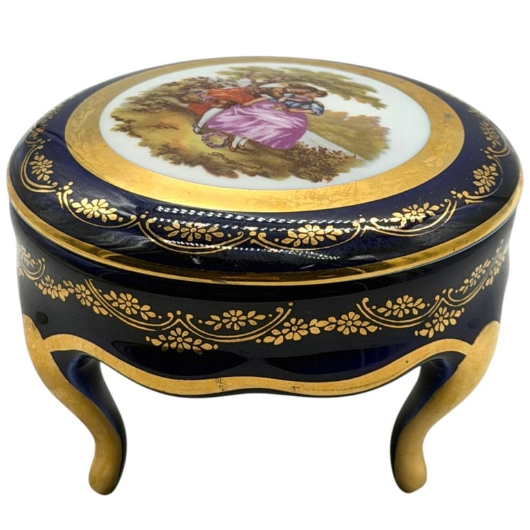 LIMOGES COBALT PORCELAIN JEWELRY CASKET 4": This elegant vintage porcelain trinket or jewelry casket features a rich cobalt blue glaze accented with extensive hand-applied gilt floral decoration. The hinged lid is adorned with a romantic courti