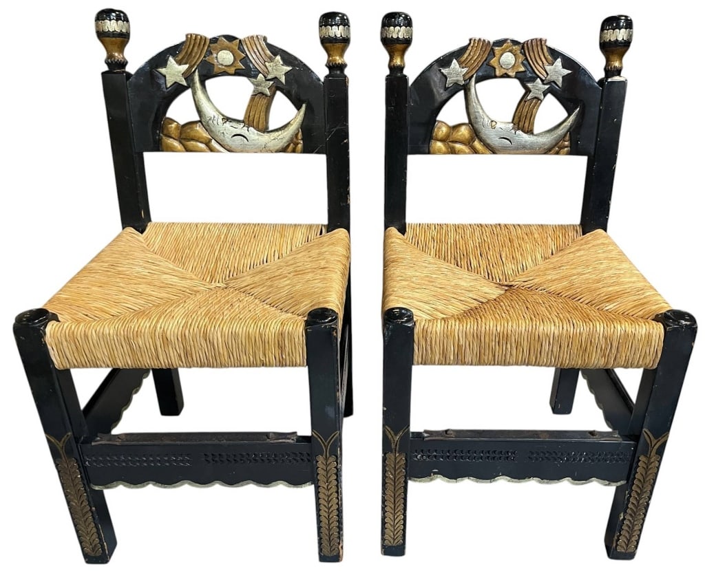 PAIR FOLK ART RUSH SEAT CHAIRS 33": This charming pair of handcrafted folk art chairs features handwoven rush seats and whimsical carved crest rails decorated with a crescent moon, stars, clouds, and celestial motifs in hand-painted bla