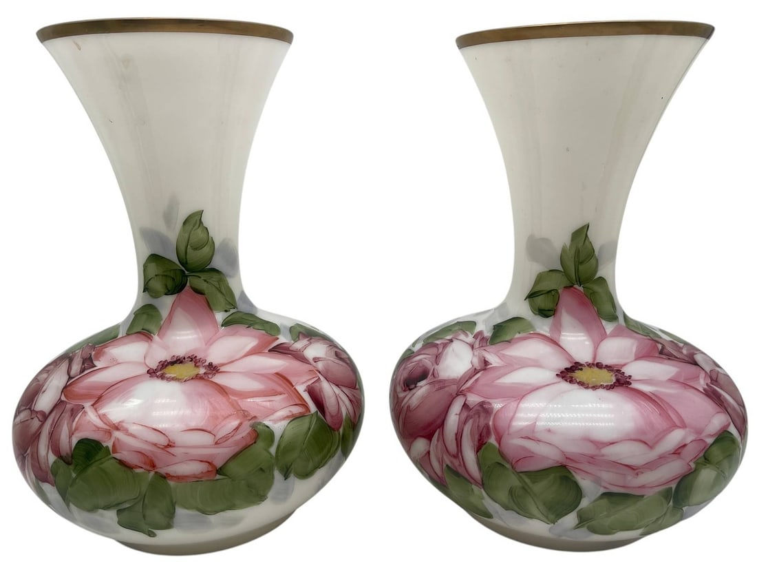 ALMO HAND PAINTED ART GLASS VASES PAIR 11.5": Elegant pair of hand-painted art glass vases signed Almo. Each vase features a graceful bulbous body with a flared trumpet neck, beautifully decorated with large pink floral blossoms and lush green fo
