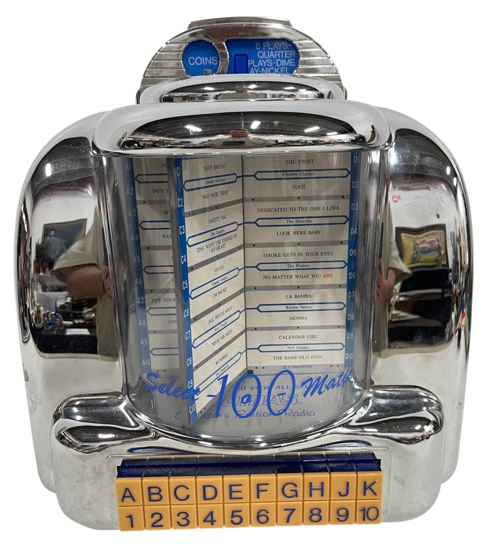 THOMAS COLLECTOR'S EDITION JUKEBOX RADIO 13": Thomas Collector's Edition tabletop jukebox-style AM/FM radio featuring a classic chrome-inspired Art Deco design with rotating song title display and vintage push-button selection panel. Model