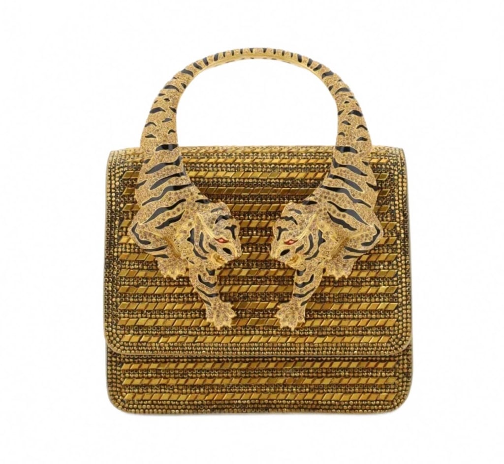 Roberto Cavalli Limited Edition Tiger Handle: Roberto Cavalli Limited Edition handbag featuring a distinctive gold-tone design with twin tigers as the handle. The structured bag is adorned with textured gold accents and intricate detailing throug