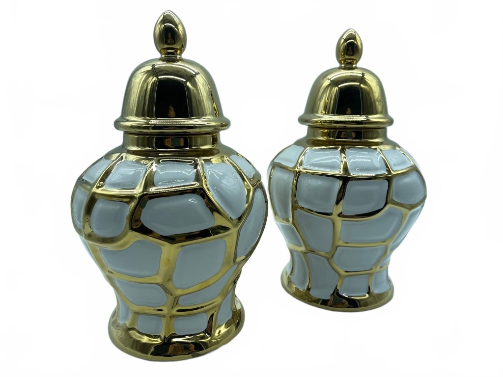 White and Gold Ceramic Ginger Jars: Elegant pair of ceramic ginger jars, each featuring a glossy white finish with a bold geometric gold overlay and matching gold lids. Approximate height is 10 inches. Perfect for decorative or function