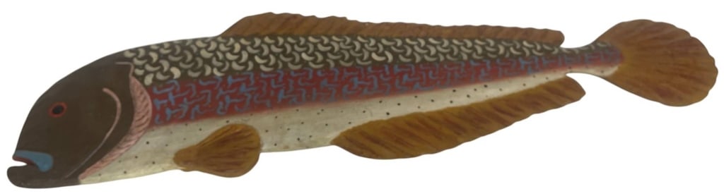 HAND PAINTED CARVED WOOD FISH 44": Large carved wood fish sculpture featuring a stylized elongated form with dimensional fins, open mouth, and a broad carved tail. The surface is hand painted in earthy brown, cream, rust, blue, turquoi