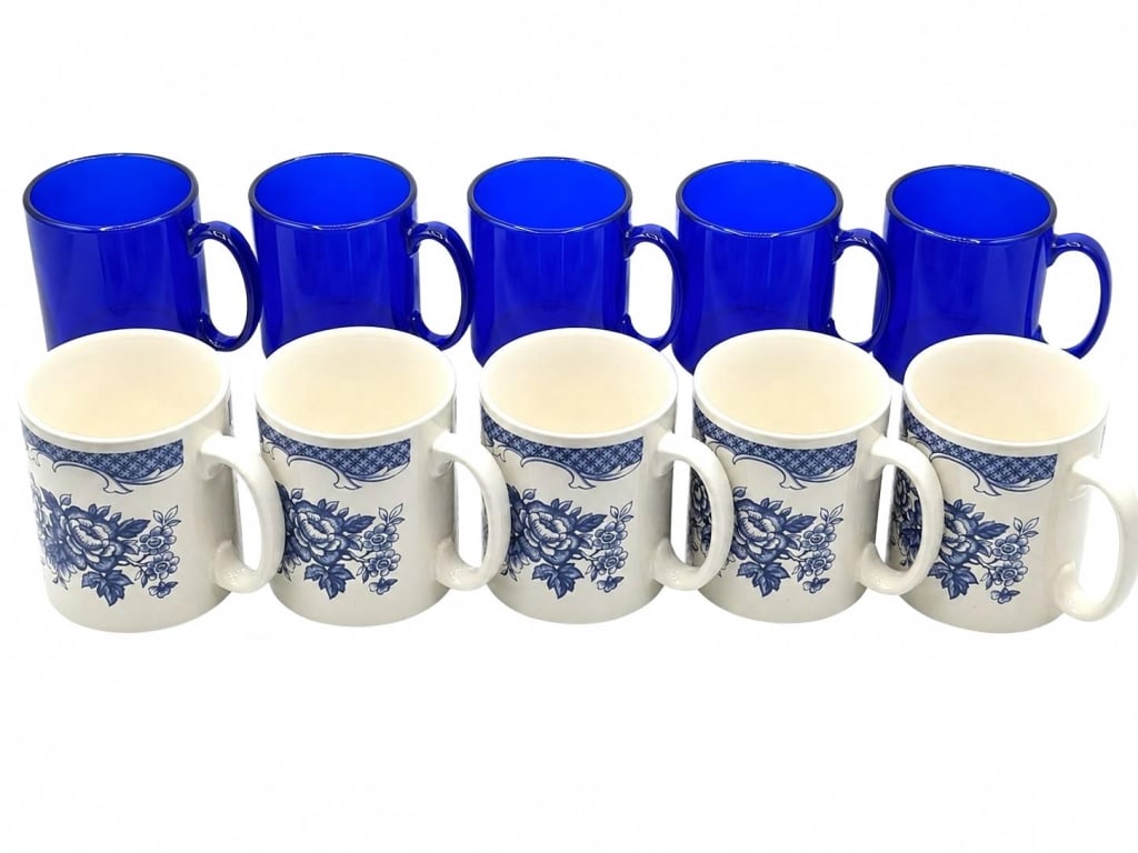 TAMS ENGLAND & BLUE GLASS MUG LOT 4": This lot includes ten coffee mugs, comprised of five Tams Made in England ceramic mugs and five unbranded translucent cobalt blue glass mugs. The English mugs feature a classic blue floral transferwar