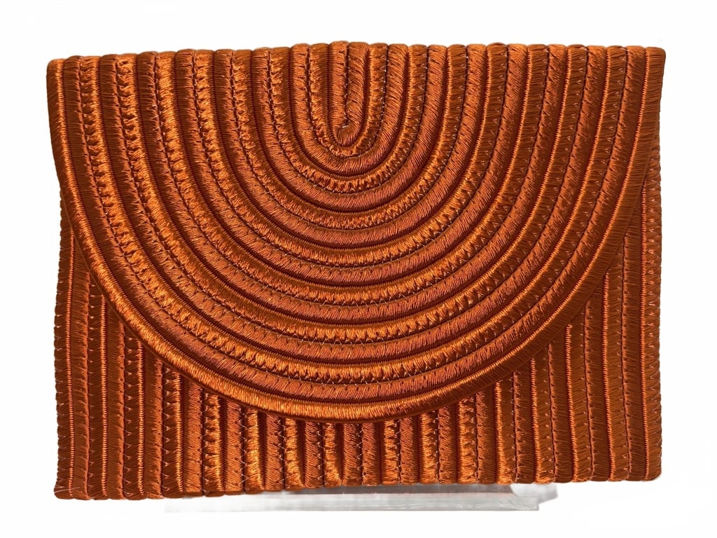 Orange Satin Envelope Clutch Purse: Satin envelope clutch purse with concentric stitched patterns in an orange shade. Features a flap closure and vertical stitching on the back. Measures approximately 5 inches by 5.75 inches. No