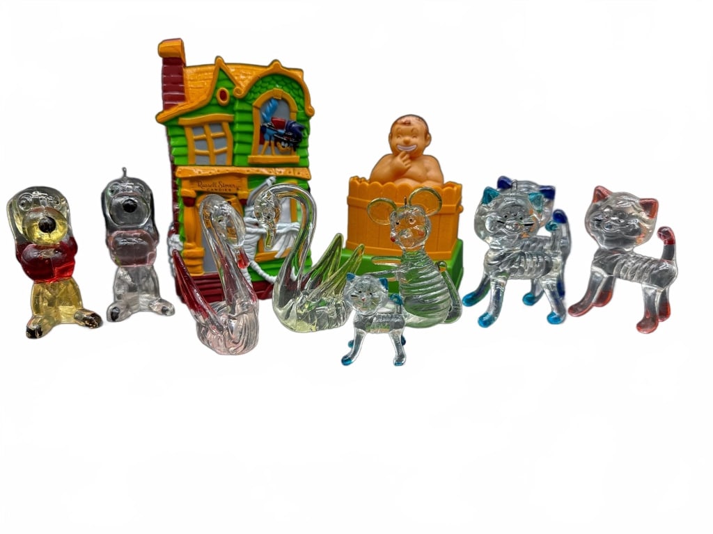 Lot Miniature Glass Animals and Toys: Miniature glass animal figurines, including swans, dogs, and a mouse, along with two plastic novelty toys: a haunted house and a baby in a tub. Tallest item is approximately 4.5 inches in height.