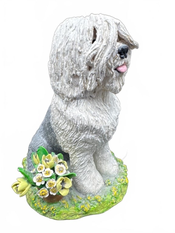 Shaggy Dog Ceramic Figurine with Flowers: Handcrafted ceramic figurine of a shaggy dog with white and gray textured fur, seated on a grassy base with yellow and white flowers. Approximate height is 8 inches. Detailed features and painted