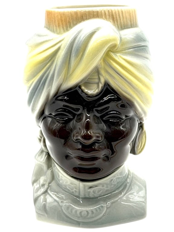 ROYAL COPLEY BLACKAMOOR WALL POCKET VASE 8": Vintage Royal Copley ceramic wall pocket vase featuring a sculptural Blackamoor figure with a white turban and robe, glossy black glazed face, and pale blue accents. Designed as a decorative wall pock