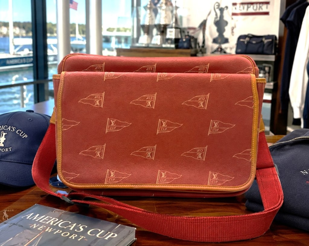 LOUIS VUITTON LV CUP MESSENGER BAG 16": Handsome Louis Vuitton LV Cup messenger bag featuring the limited-edition LV Cup regatta motif in rich red coated canvas with gold-tone pennant graphics, natural leather trim, and an adjustable red ca