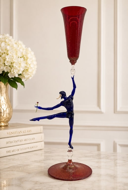 LUCIO BUBACCO FIGURAL MURANO ART GLASS GOBLET 20": This extraordinary hand-blown Murano art glass goblet by acclaimed Venetian master Lucio Bubacco features an elegant ruby red trumpet-form bowl supported by a dramatic cobalt blue figural stem depicti