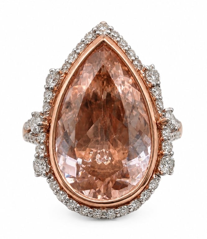 14K GOLD 15CT MORGANITE & .54CT DIAMOND HALO RING: 14 karat two-tone rose and white gold ladies ring featuring a natural pear brilliant-cut morganite beryl center stone weighing approximately 15.47 carats. The pinkish-orange 'peach' morganite is accen
