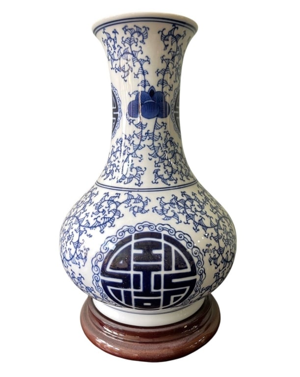 CHINESE BLUE AND WHITE PORCELAIN VASE 13": This traditional Chinese porcelain vase features intricate blue and white designs with floral and geometric motifs throughout. The bulbous body and narrow neck add elegance, while the vase is displaye