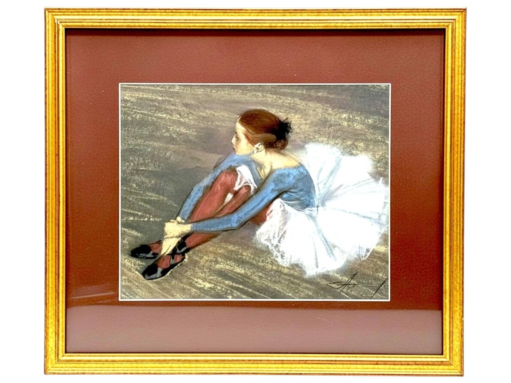 VLADIMIR AKIMKIN FRAMED PASTEL BALLERINA 18": Framed pastel on paper depicting a seated ballerina adjusting her ballet slippers, rendered in soft, expressive tones with a dramatic white tutu and muted stage background. Signed lower right and acco