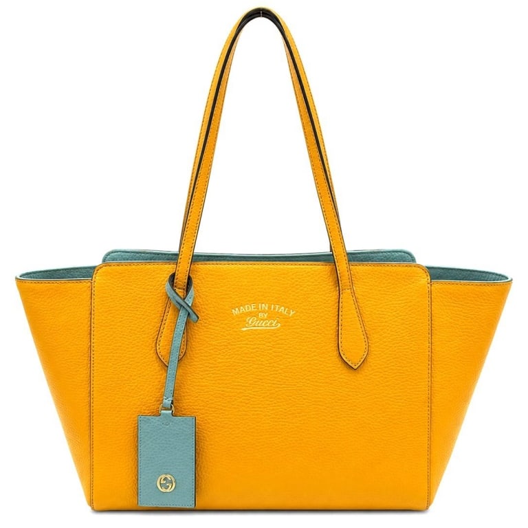 GUCCI CITRUS & LIGHT BLUE LEATHER TOTE 16": This Gucci tote is crafted in citrus grained leather with a contrasting light blue leather interior, allowing the bag to be worn on either side. Made in Italy, it features dual shoulder straps, an ope