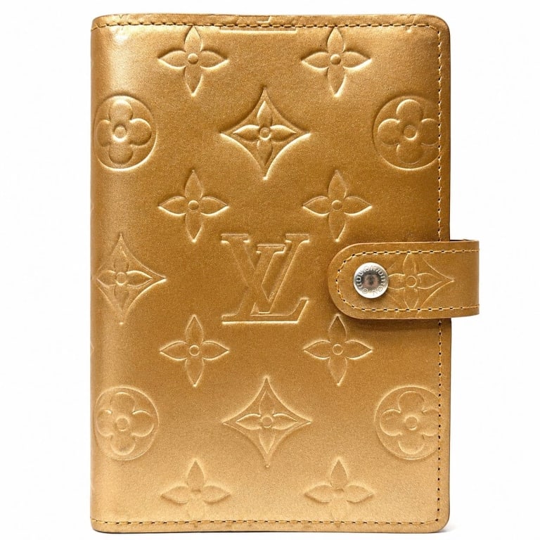 LOUIS VUITTON MONOGRAM VERNIS AGENDA PM 5": This Louis Vuitton Monogram Vernis Agenda PM is crafted in elegant champagne-colored Monogram Vernis patent leather with a snap-tab closure and polished silver-tone six-ring binder mechanism. The comp