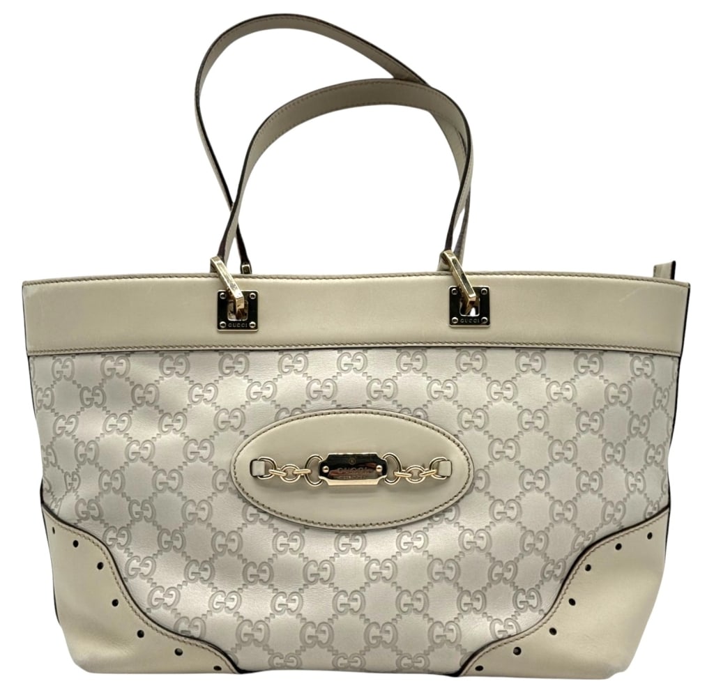 GUCCI WHITE GUCCISMA MEDIUM TOTE BAG 9" X 15": Gucci medium tote bag in white Guccissima embossed leather with gold-tone hardware and signature horsebit-inspired front detail. Features dual shoulder straps, zip-top closure, brown textile lining, i