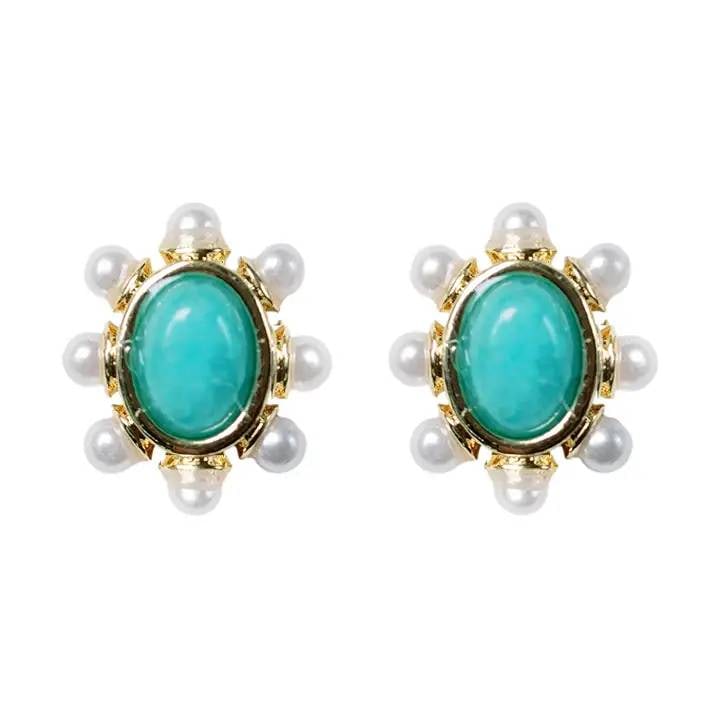 TURQUOISE AND PEARL DSTUD EARRINGS: Vintage gold tones are among this year's biggest trends, and we are delighted to introduce our newest stud earrings featuring a stunning turquoise stone at the center, outlined by delicate pearls. Thi