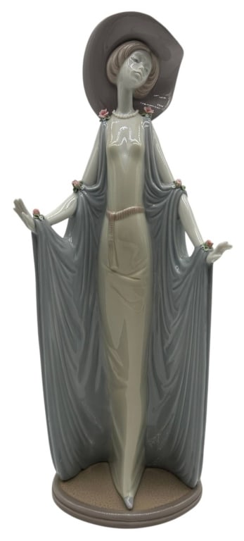 LLADRO LADY WITH SHAWL FIGURINE 14": Elegant Lladró porcelain figurine depicting a graceful young woman in a flowing ivory gown with soft gray draped shawl, adorned with delicate pink floral accents and wearing a wide-brimmed hat. Beaut